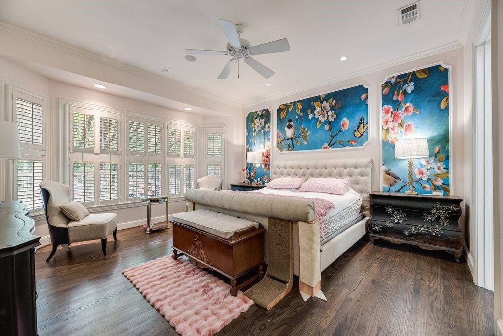 1418 Yakimo Drive, Dallas, TX 75208 Dark wood-finish flooring, bay window with plantation shutters, custom framed wall murals, recessed lighting, and a ceiling fan