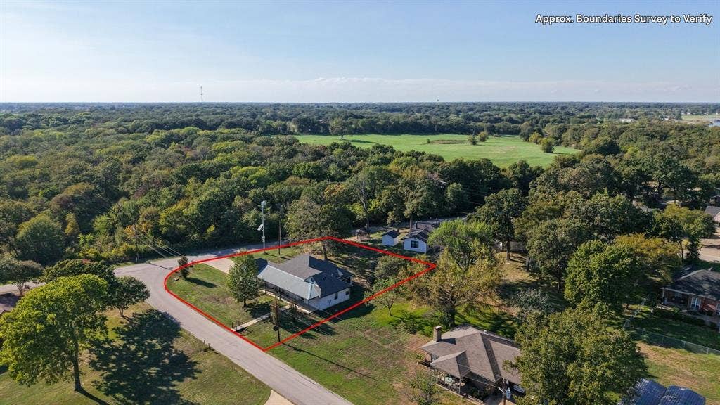 409 Oak Creek Drive, Tool, TX 75143 Aerial view highlighting the home's corner lot and surrounding wooded setting.