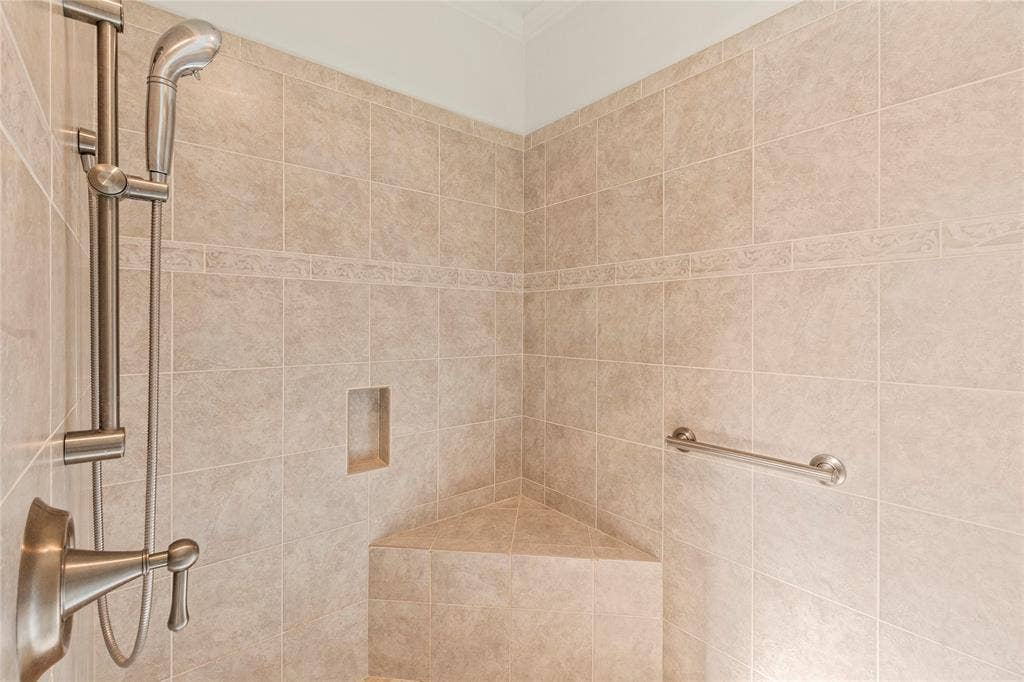 409 Oak Creek Drive, Tool, TX 75143 Ensuite bathroom two with double-sink granite vanity, generous cabinet storage, and walk-in tiled shower.