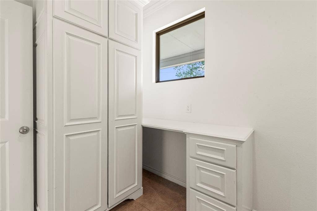 409 Oak Creek Drive, Tool, TX 75143 Laundry room featuring floor-to-ceiling cabinetry, built-in drawers, and countertop space for extra storage.