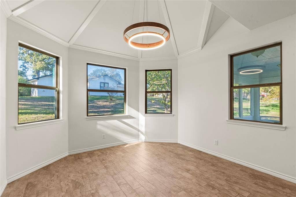 409 Oak Creek Drive, Tool, TX 75143 Dining area surrounded by windows providing abundant natural light and views of the outdoors.