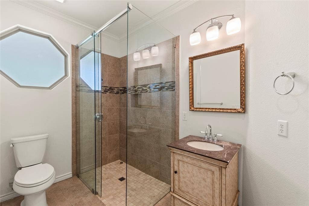 409 Oak Creek Drive, Tool, TX 75143 Ensuite bathroom One featuring a tiled walk-in shower with glass enclosure and decorative vanity.