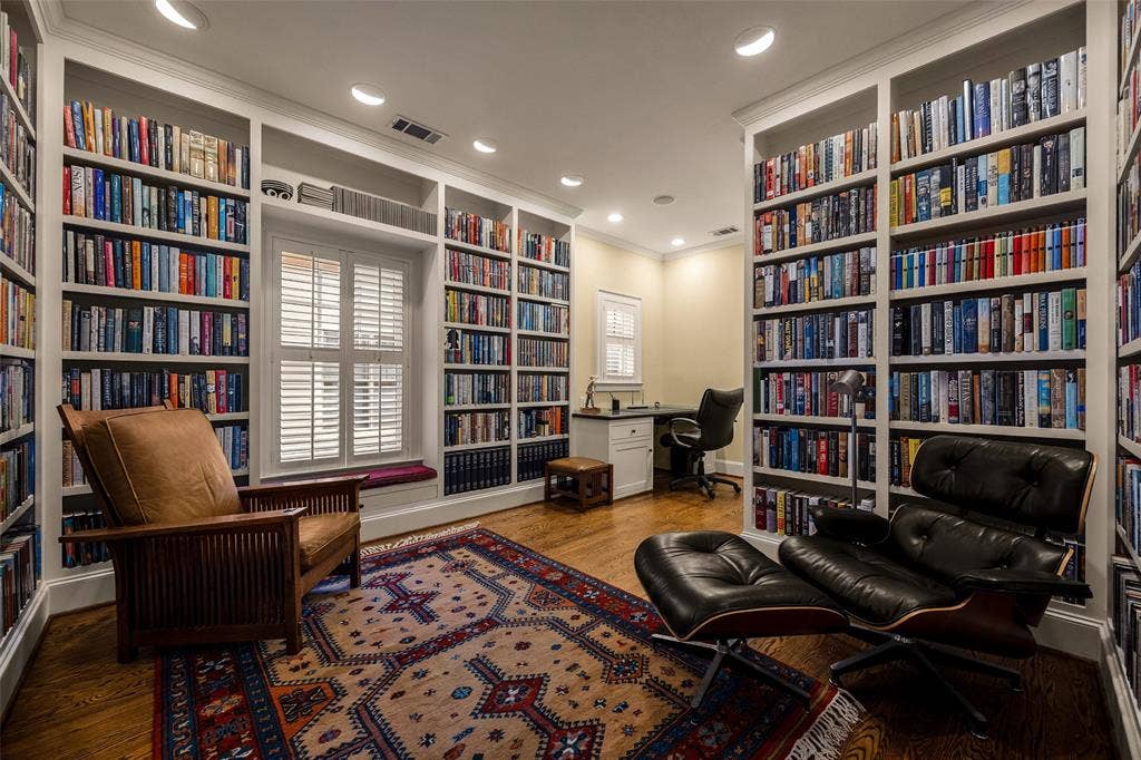 6020 Tremont Street, Dallas, TX 75214 Floor-to-ceiling custom built-in shelving, hardwood flooring, recessed lighting, integrated window seat, and built-in desk