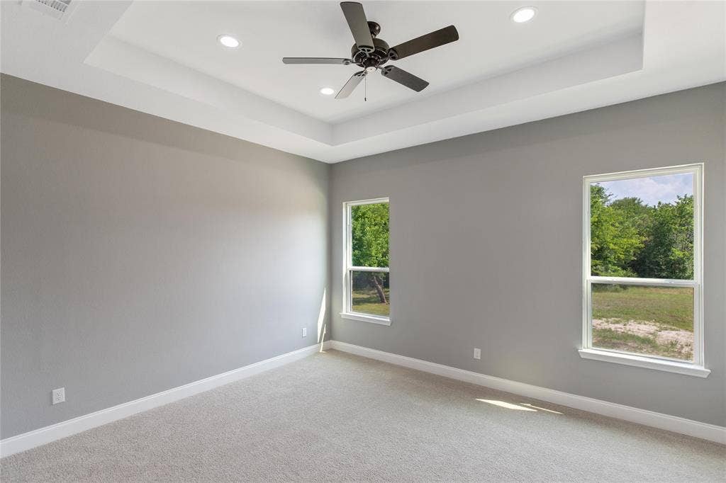 10560 Lago Vista, Quinlan, TX 75474 Empty room with a tray ceiling, carpet floors, recessed lighting, and ceiling fan
