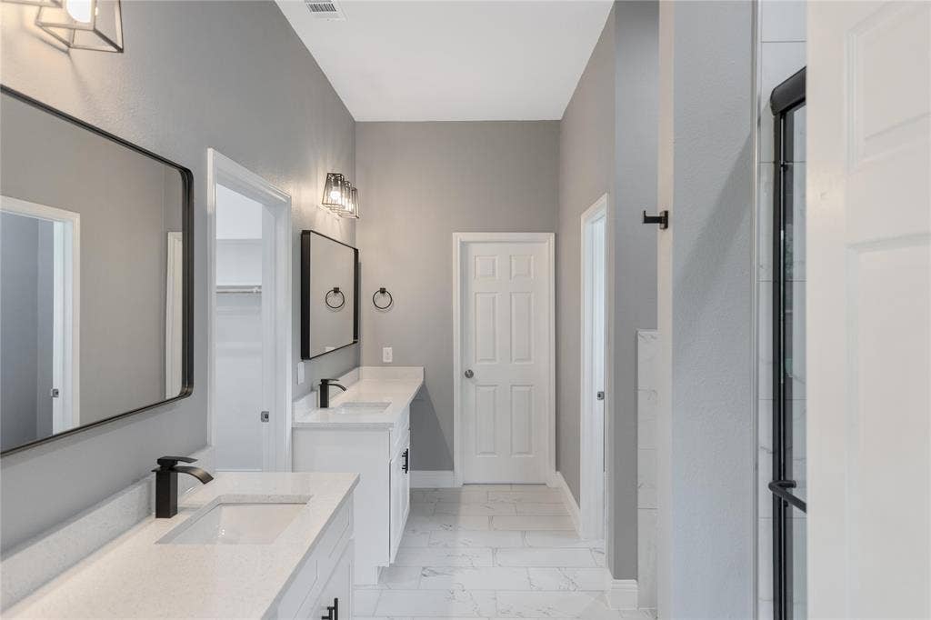 10560 Lago Vista, Quinlan, TX 75474 Full bathroom featuring two vanities and light marble finish flooring