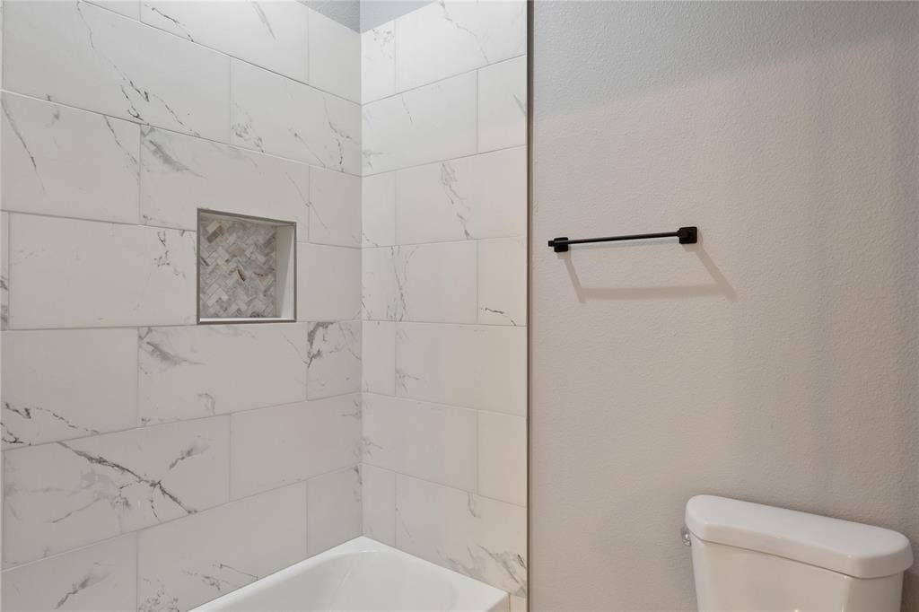 10560 Lago Vista, Quinlan, TX 75474 Full bath with shower / bathtub combination and a textured wall