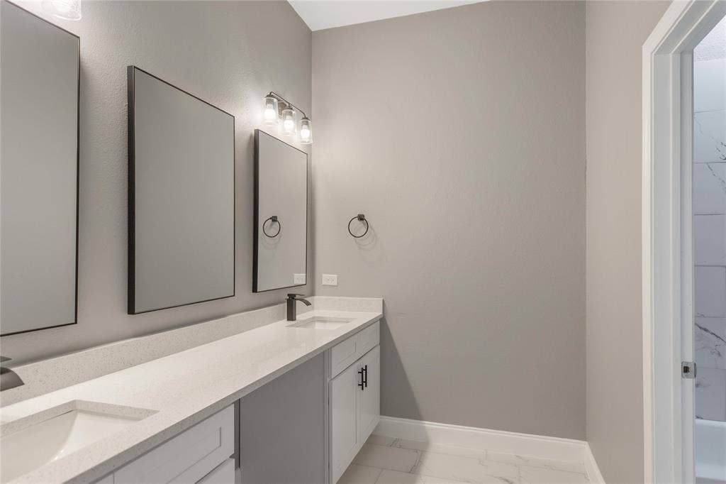 10560 Lago Vista, Quinlan, TX 75474 Bathroom with double vanity and light marble finish floors