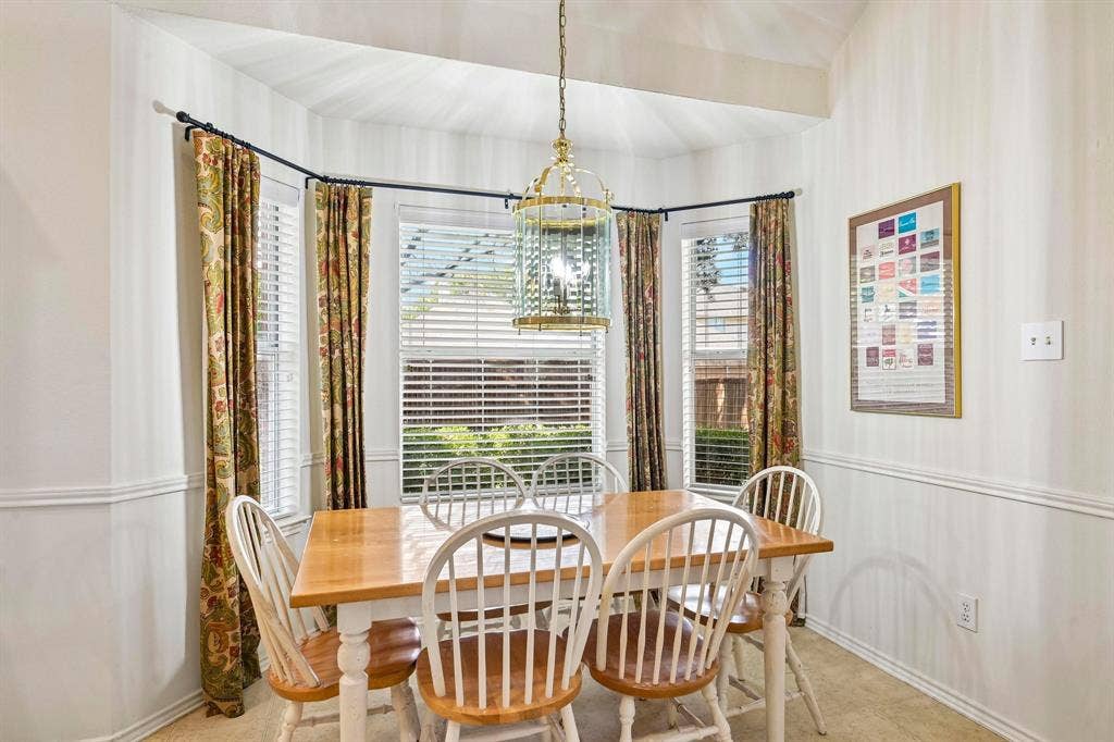 758 Livingston Drive, Allen, TX 75002 Bay window featuring three large windows with horizontal blinds, crowned by a metallic lantern-style pendant light fixture and finished with chair rail molding