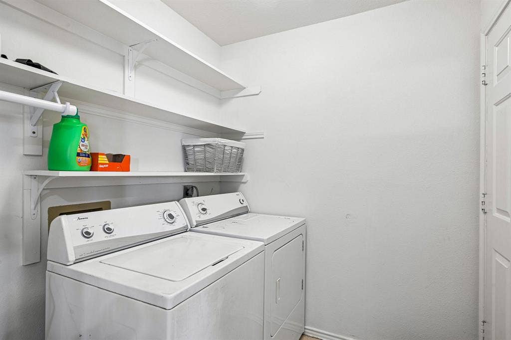 758 Livingston Drive, Allen, TX 75002 Laundry room featuring tiered white built-in wall shelving and white-paneled door
