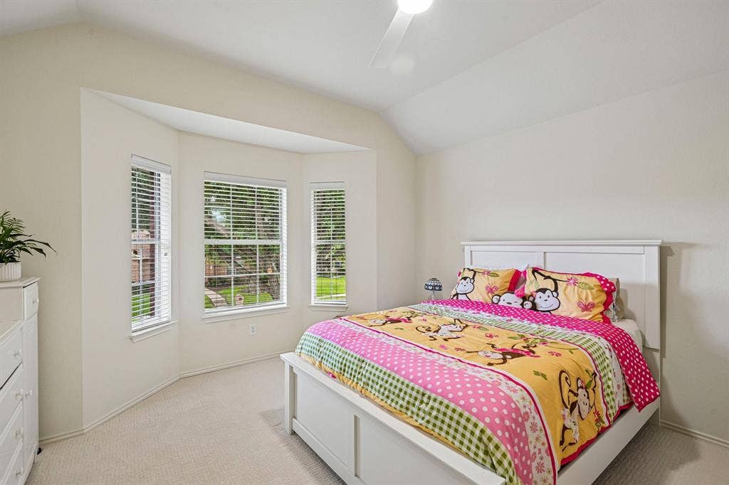 758 Livingston Drive, Allen, TX 75002 Vaulted ceiling with a central paddle fan, expansive bay window, and neutral carpeting