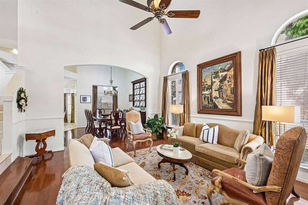 758 Livingston Drive, Allen, TX 75002 Living area featuring vaulted ceilings, arched windows, wood-finish flooring, and a ceiling fan