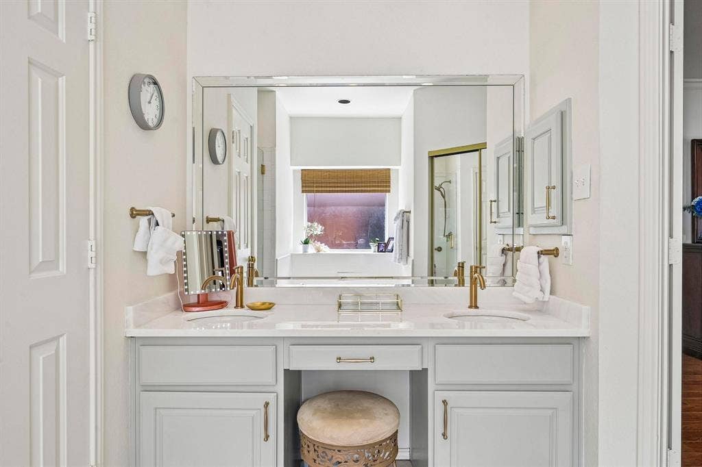 758 Livingston Drive, Allen, TX 75002 Double vanity with a light-toned countertop, integrated dual sinks, brass-finish hardware, and a large wall-mounted mirror