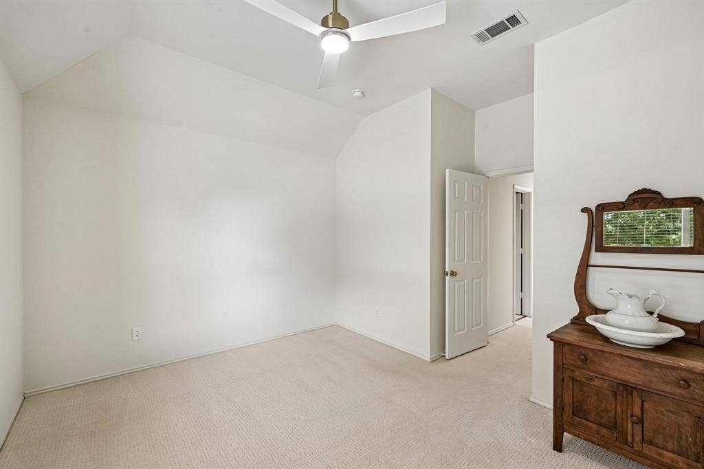 758 Livingston Drive, Allen, TX 75002 Room featuring vaulted ceilings, neutral carpeting, and a modern brushed-metal ceiling fan with integrated lighting