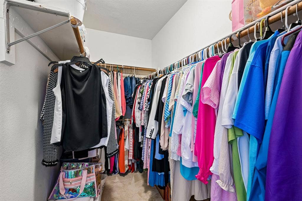 758 Livingston Drive, Allen, TX 75002 Walk-in closet featuring dual-level wooden shelving and wall-mounted rod hardware
