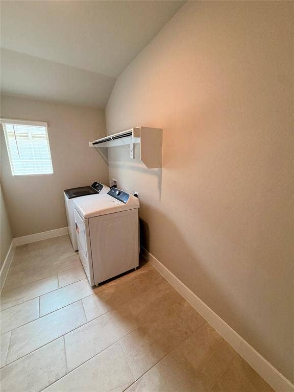Laundry area featuring large-format ceramic tile flooring, a wall-mounted white storage shelf with integrated rod, and a window with horizontal blinds