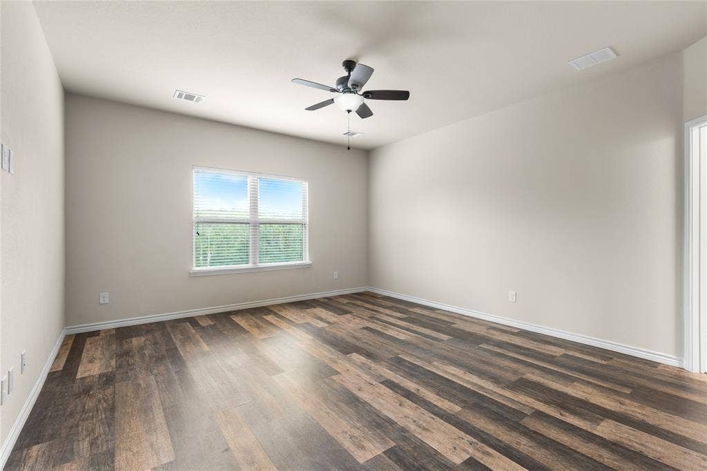 5751 Mountain Hollow Drive, Dallas, TX 75249 Room featuring neutral wall paint, wood-finish flooring, a multi-blade ceiling fan with integrated lighting, and a window with horizontal blinds