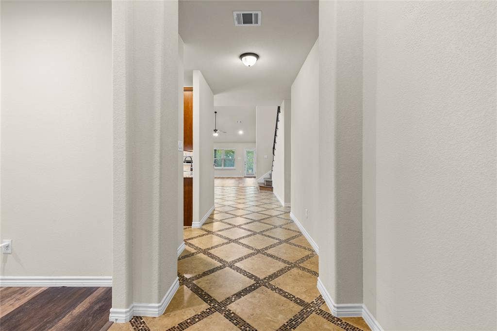 5751 Mountain Hollow Drive, Dallas, TX 75249 Entryway featuring stone-tile flooring with decorative mosaic inlay, neutral wall paint, and recessed lighting