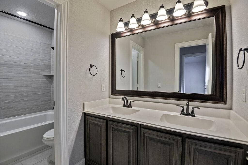 This is a full bathroom upstairs - one room separated into 2 private spaces by a door.