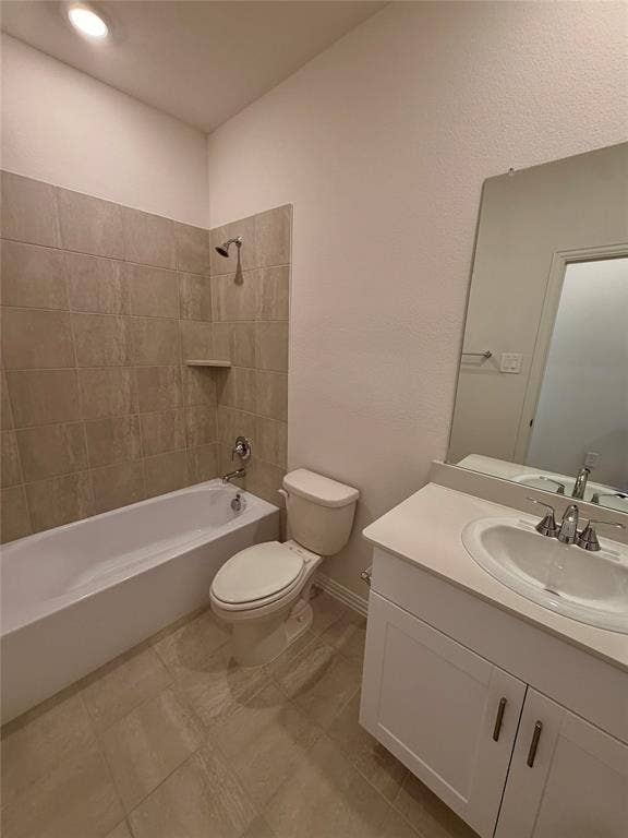 Bathroom featuring a white vanity cabinet with a light-toned countertop, an integrated sink with a chrome faucet, a tub-shower combination with floor-to-ceiling tile surround, and tile flooring