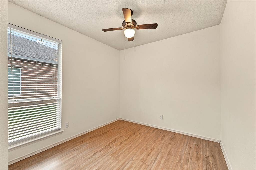 The second of the two split living secondary bedrooms. High ceilings and a large window are featured in this space as well.