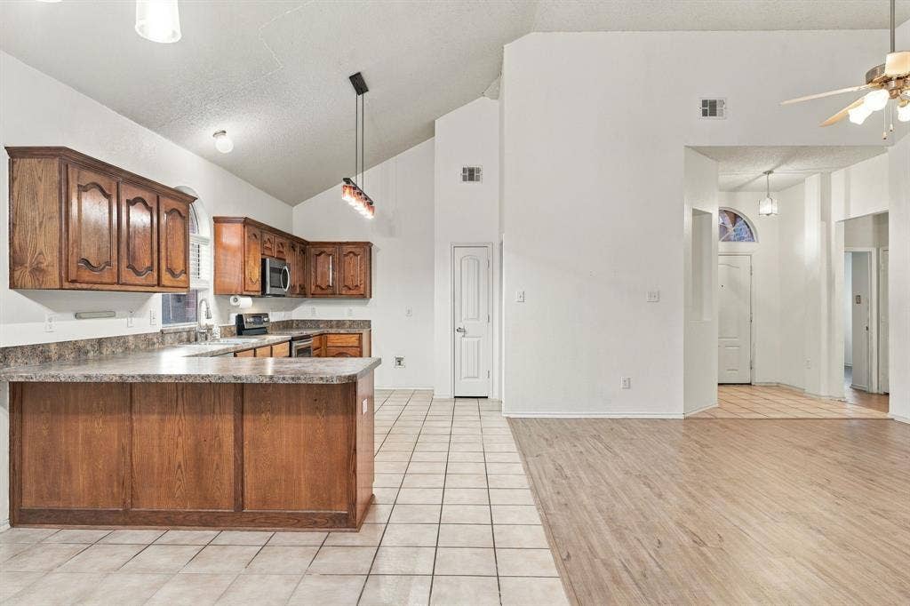 The kitchen, living area and dining area flow seamlessly together allowing for functionality, entertaining, convenience and warmth.  Notice the high ceilings, natural light and beautiful architectural detail.