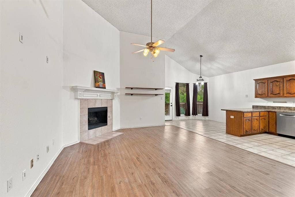 The open Living space flows into the kitchen and the dining area, perfect for gathering or relaxing in front of the fireplace! Notice the high ceilings!