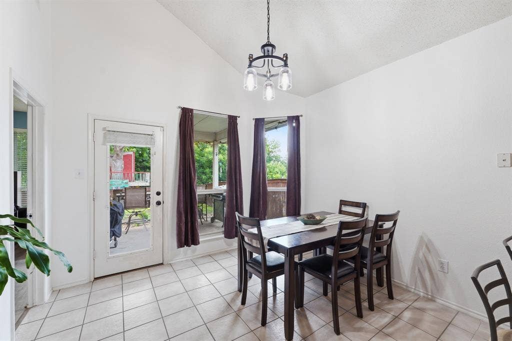 The breakfast room leads directly into the private backyard. Notice the natural light and high ceilings even in this area.  Photo taken prior to the owner vacating.