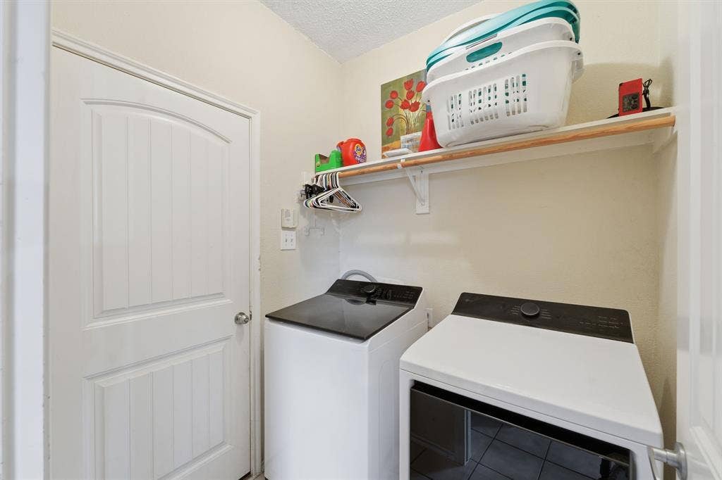 Space for a full-sized washer and dryer, plus drip dry area and even more storage.  Photo was taken prior to owner vacating.