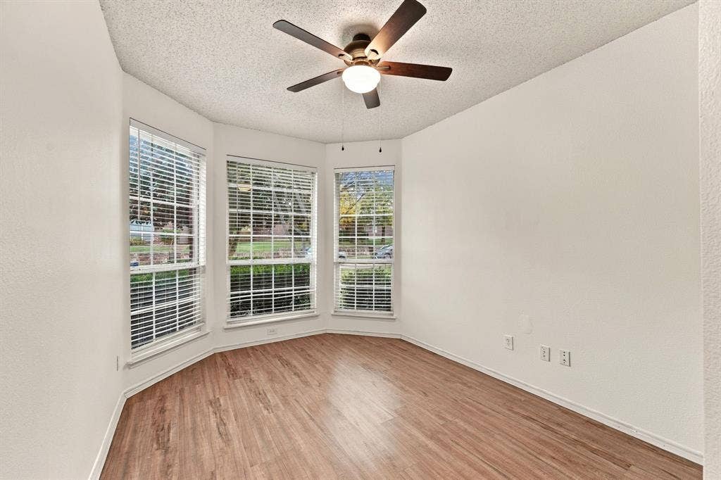 The first of the two split living secondary bedrooms. Notice the wall of windows and high ceilings.