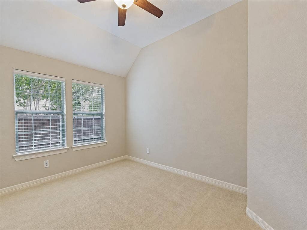 604 Barkley Drive, McKinney, TX 75071 Vaulted ceiling featuring a ceiling fan with integrated lighting and two windows with horizontal blinds