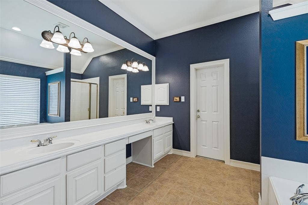 604 Barkley Drive, McKinney, TX 75071 Large vanity featuring white cabinetry, integrated sinks, a sprawling wall-to-wall mirror, and overhead multi-bulb lighting fixtures