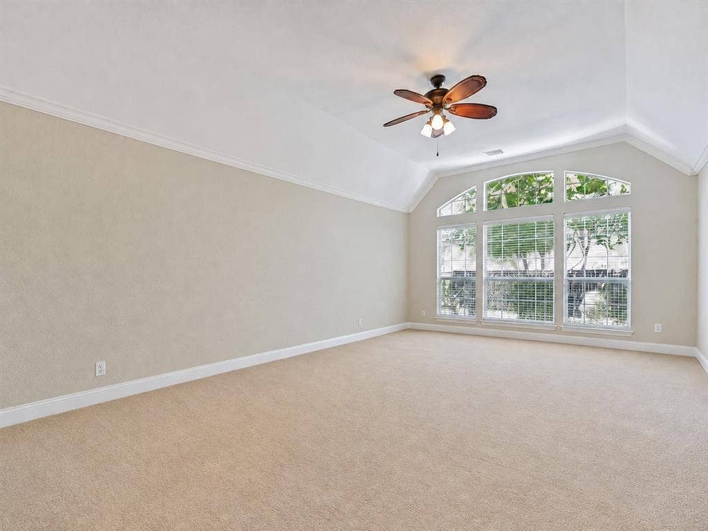 604 Barkley Drive, McKinney, TX 75071 Vaulted ceilings featuring a multi-light ceiling fan and an expansive arched window assembly