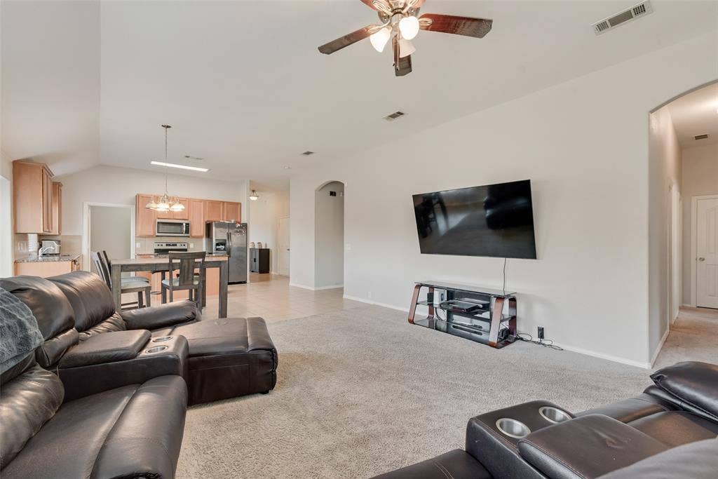 721 Honeysuckle Way, DeSoto, TX 75115 Open-concept interior featuring vaulted ceilings, neutral wall tones, recessed lighting, and a ceiling fan!
