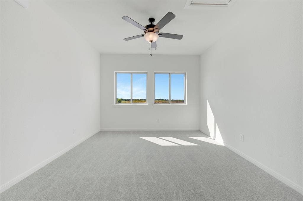 3469 Jersey Drive, Midlothian, TX 76065 Interior room featuring wall-to-wall carpeting, dual windows, and a ceiling-mounted light fixture with a fan
