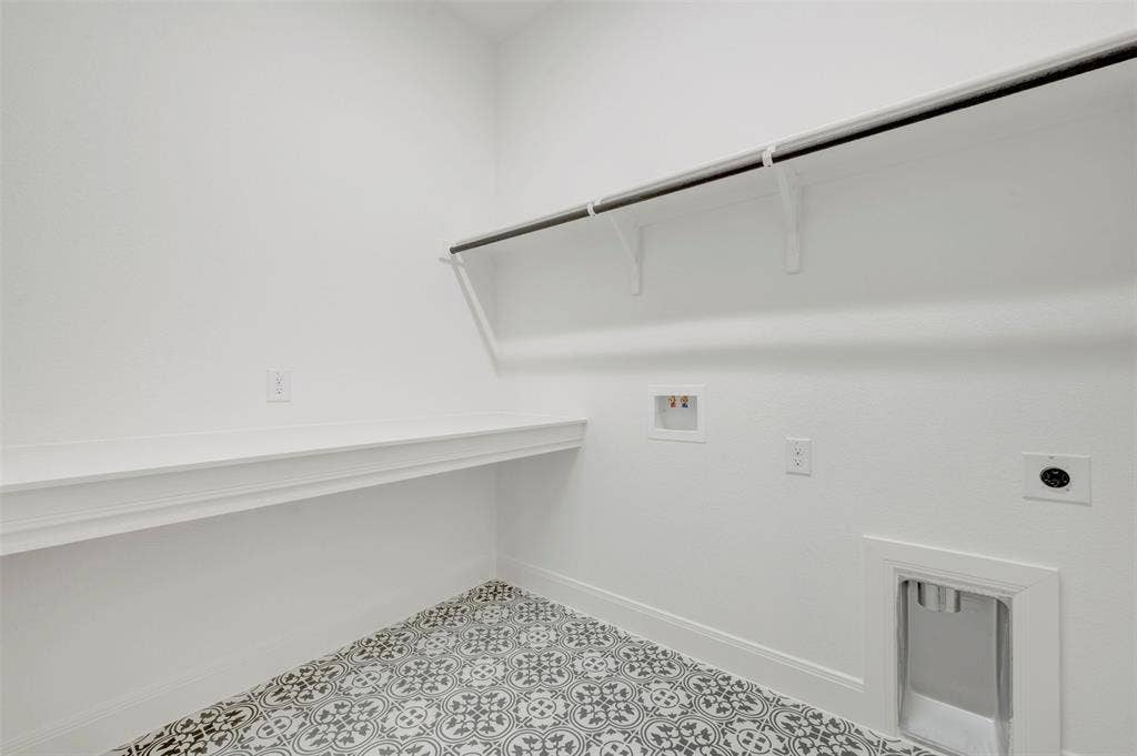 3469 Jersey Drive, Midlothian, TX 76065 Laundry room featuring patterned tile flooring, built-in shelving, a wall-mounted hanging rod, and dedicated appliance hookups