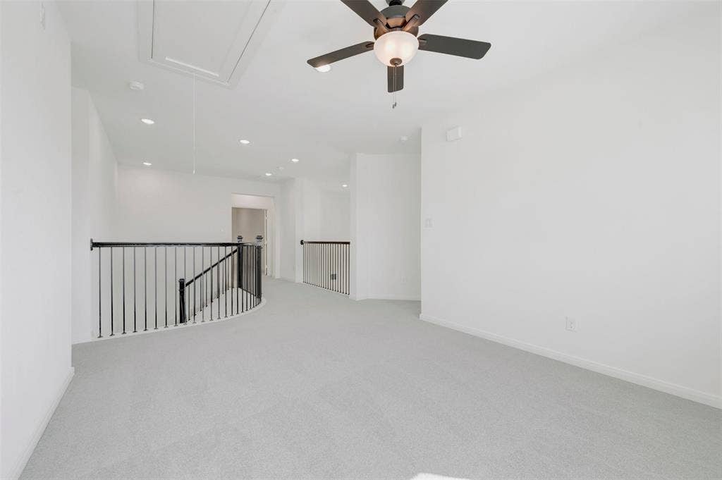 3469 Jersey Drive, Midlothian, TX 76065 Open interior space featuring neutral carpeting, recessed lighting, a ceiling fan with integrated light fixture, and black metal spindle railing
