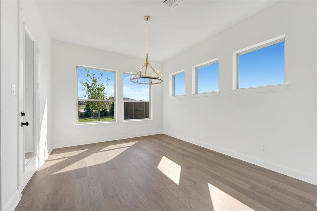 3469 Jersey Drive, Midlothian, TX 76065 Wood-finish flooring, multi-pane windows, and a metal chandelier fixture