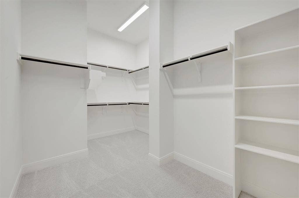 3469 Jersey Drive, Midlothian, TX 76065 Walk-in closet featuring wall-to-wall carpeting, tiered hanging rods, and built-in shelving units