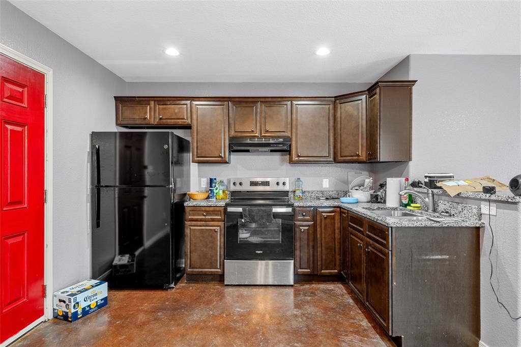 2125 Burnett Avenue, Waco, TX 76706 Unit A Kitchen featuring stained wood cabinetry, stone-finish countertops, stainless steel electric range, black refrigerator, and recessed lighting