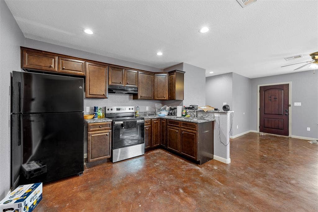 2125 Burnett Avenue, Waco, TX 76706 Unit A Kitchen featuring stained wood cabinetry, stone-finish countertops, stainless steel electric range, recessed lighting, and stained concrete flooring
