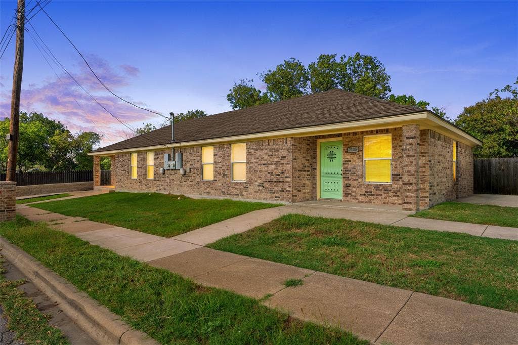 2125 Burnett Avenue, Waco, TX 76706 Single-story brick exterior featuring a hipped roof, covered front porch, and concrete walkway