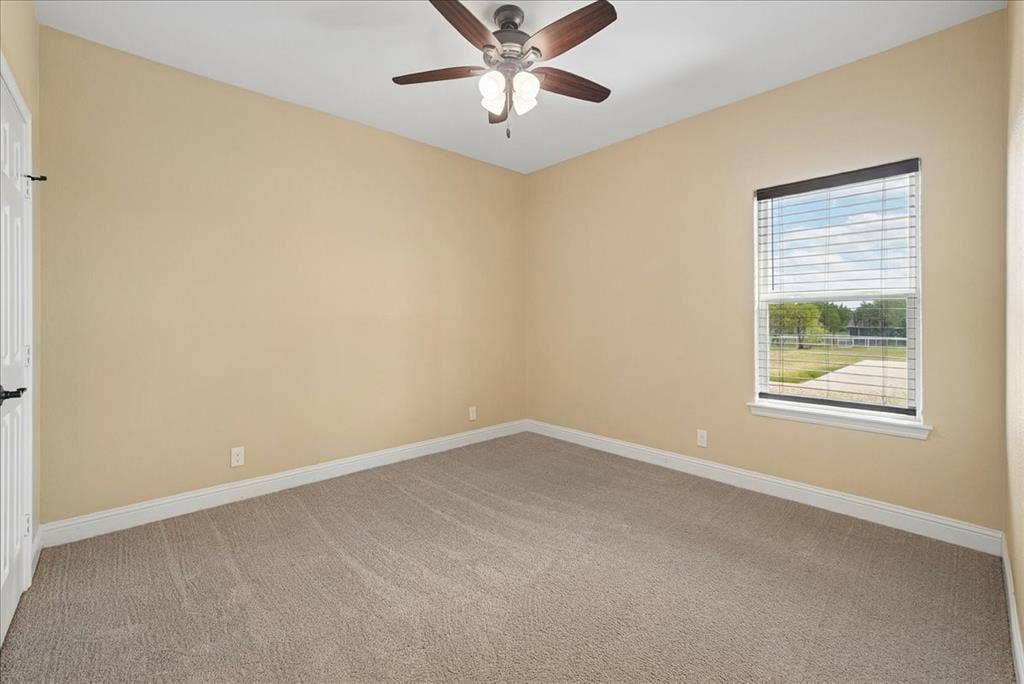 9060 Mitchell Bend Court, Granbury, TX 76048 Room featuring neutral wall tones, wall-to-wall carpeting, a multi-blade ceiling fan with integrated lighting, and a window with horizontal blinds