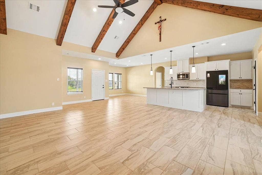 9060 Mitchell Bend Court, Granbury, TX 76048 Vaulted ceilings featuring exposed wooden beams, tile flooring, recessed lighting, and a kitchen island with pendant lighting