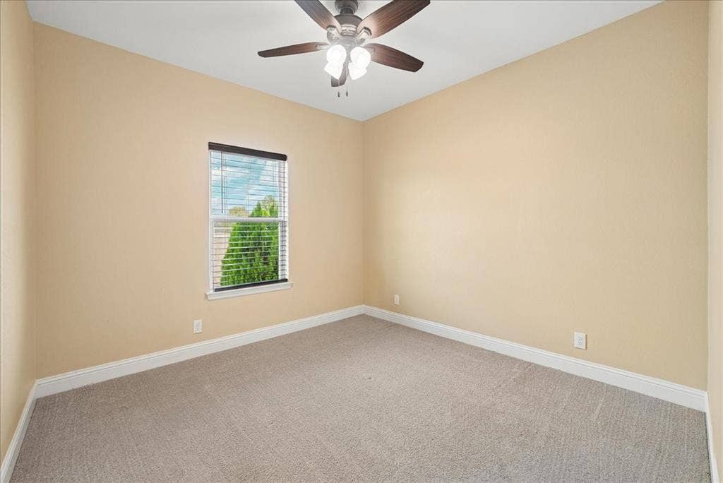 9060 Mitchell Bend Court, Granbury, TX 76048 Neutral interior room featuring neutral wall paint, carpeted flooring, a ceiling fan with integrated lighting, and a window with fitted blinds