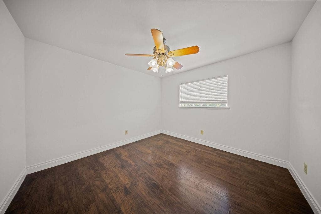 738 Intrepid Drive, Garland, TX 75043 Room featuring wood-finish flooring, a ceiling fan with integrated lighting, and a window with horizontal blinds