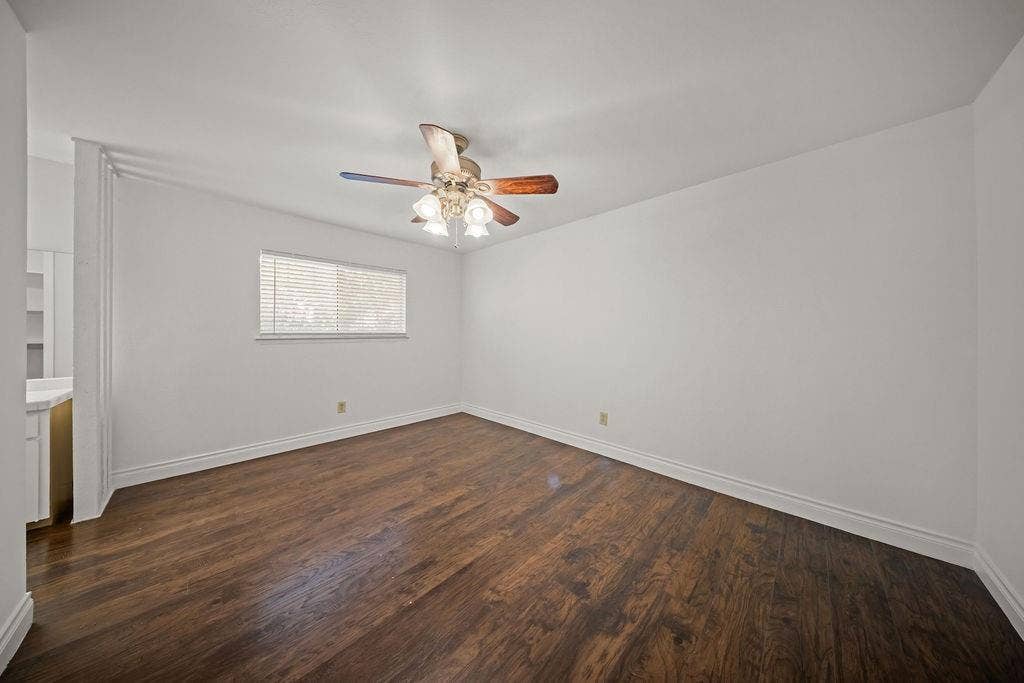 738 Intrepid Drive, Garland, TX 75043 Backyard featuring a wood privacy fence, concrete patio area, mature trees, and vinyl siding exterior