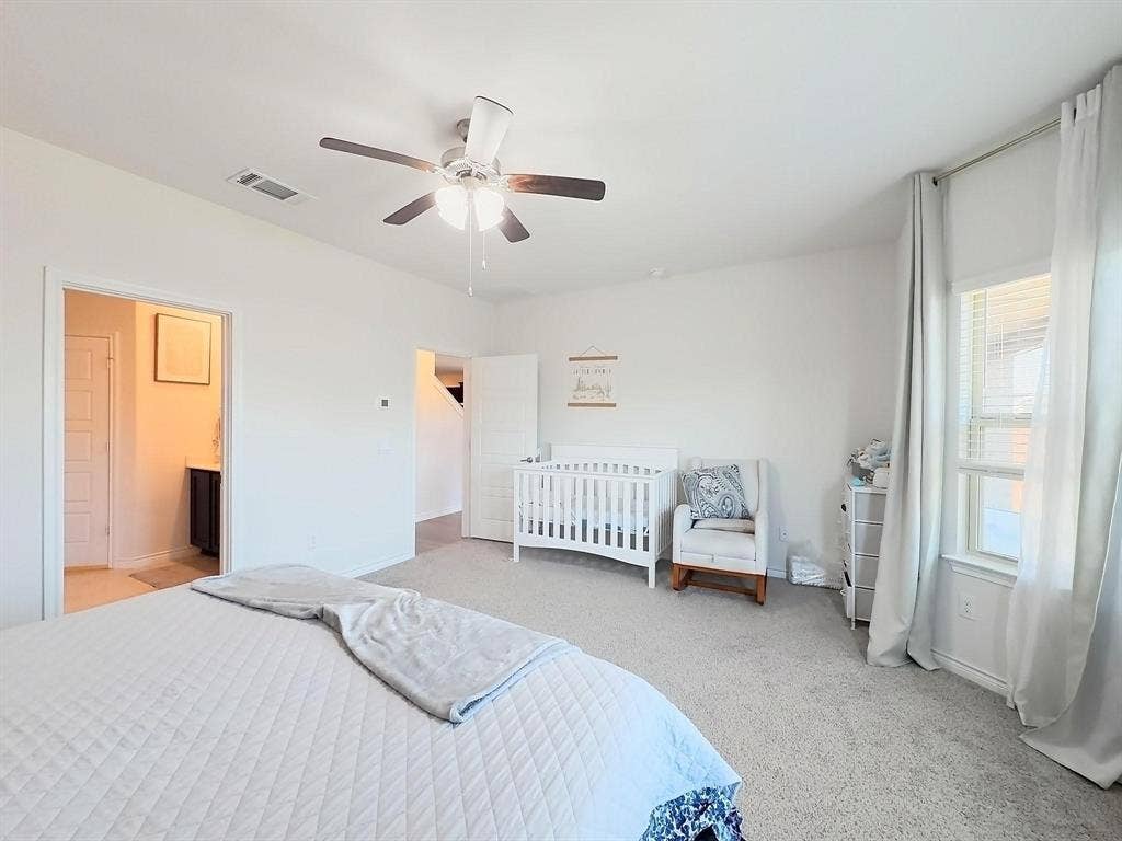 7400 Seton Place, McKinney, TX 75071 Neutral-toned carpeted flooring, multi-light ceiling fan, and large windows with full-length drapery hardware