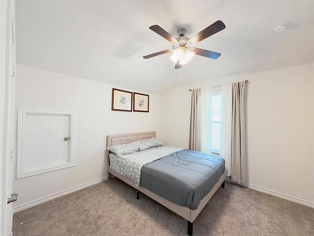 7400 Seton Place, McKinney, TX 75071 Neutral-toned carpeting, ceiling fan with integrated lighting, window with double-rod hardware, and built-in access panel