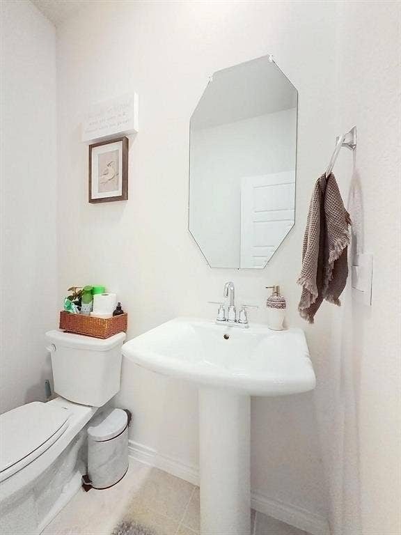 7400 Seton Place, McKinney, TX 75071 White porcelain pedestal sink with polished chrome widespread faucet, octagonal frameless wall mirror, and dual-flush toilet
