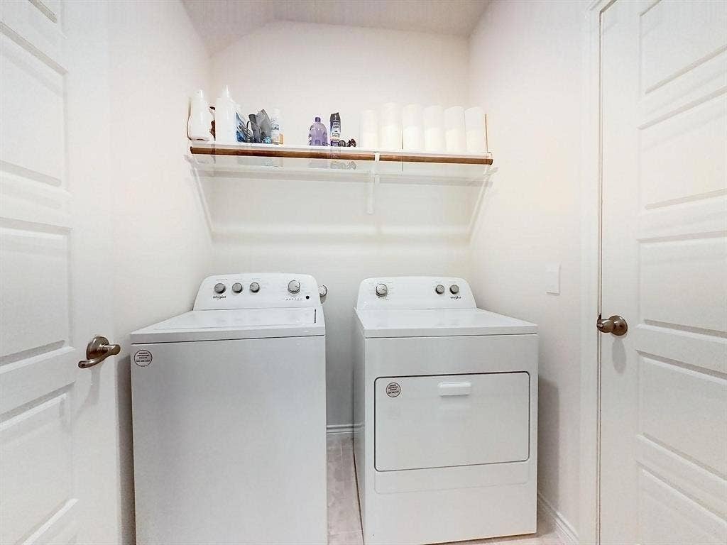 7400 Seton Place, McKinney, TX 75071 Laundry room featuring white appliance hookups, overhead wall-mounted shelving, and dual paneled doors